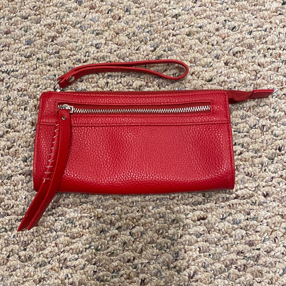 Red wristlet with zipper pouch on front with wallet pocket inside and zipper.